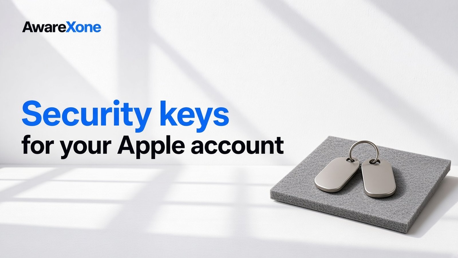 AwareXone Research cover reading 'Security keys for your Apple account' beside a photo of two metal key fobs on a ring resting on grey felt.